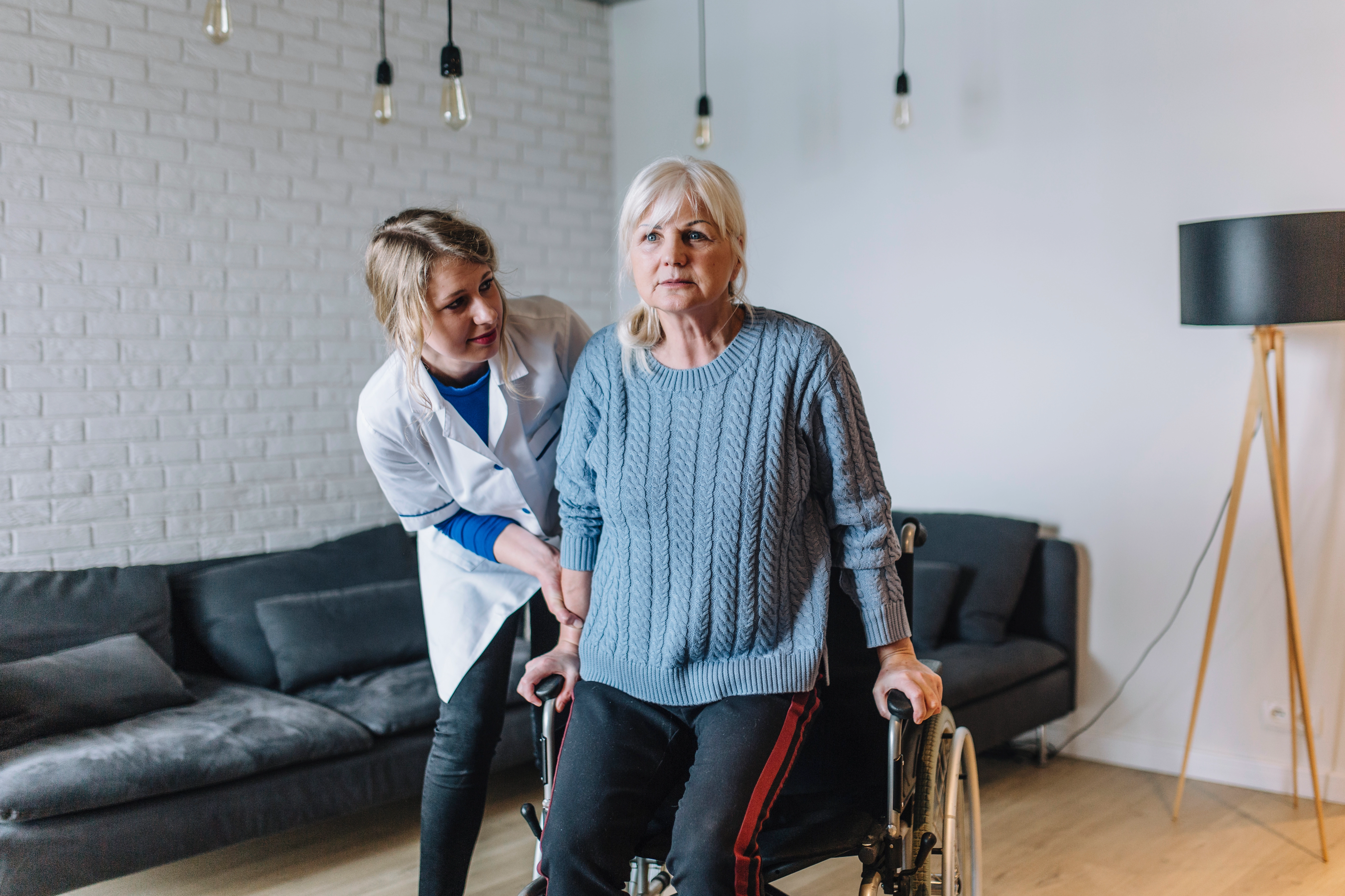 The image shows the care assistant to help the patient to walk